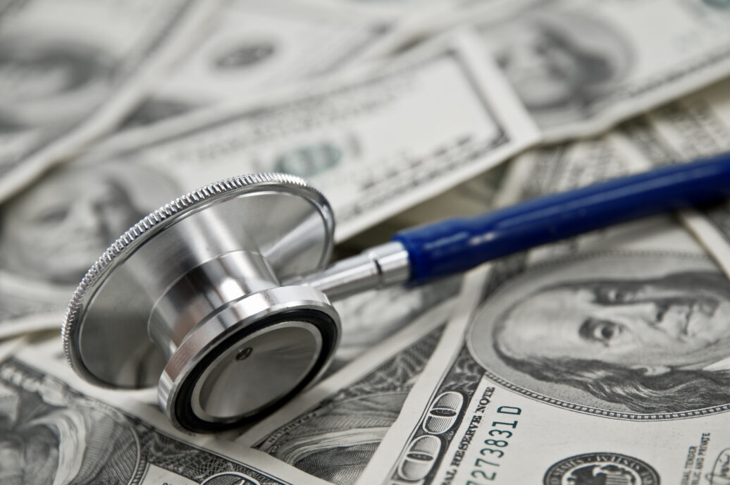 stethoscope and dollar note closeup