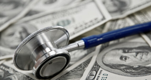 stethoscope and dollar note closeup