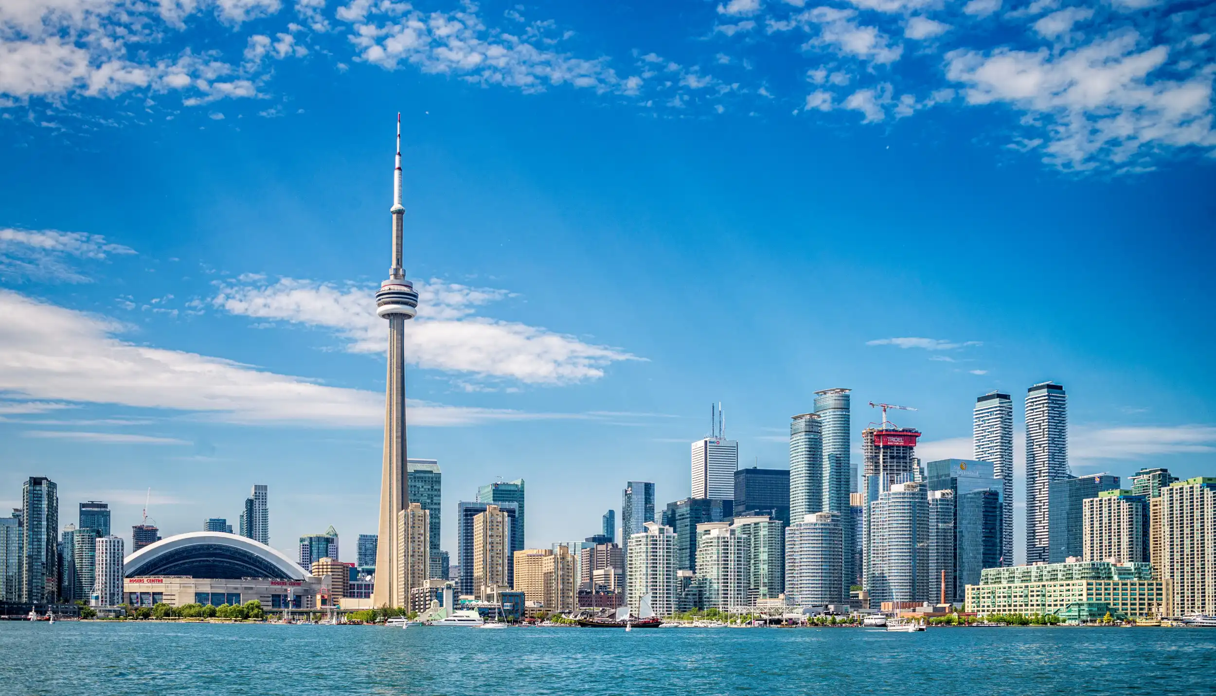 Toronto skyline featuring the CN Tower and waterfront on a clear day.