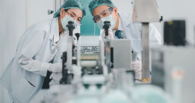 Engineers conducting pre-clinical testing of a novel medical device in a controlled laboratory environment