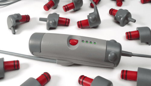 Rendered layout of LVAD recovery system controllers, connectors and tubing components arranged on a silver surface.