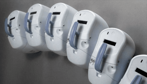 Three Inogen One Oxygen Concentrator units displayed together showing different design angles and side profiles.