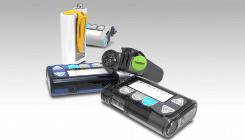 Assortment of MiniMed insulin pumps with infusion sets, reservoirs and accessories displayed together on a white background.