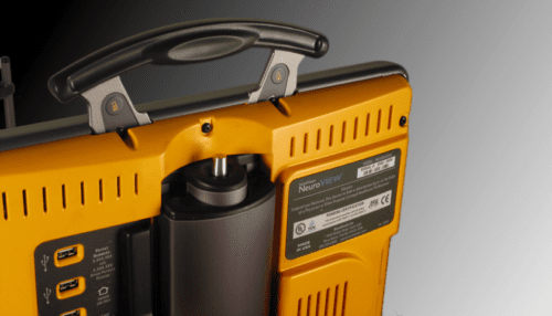 Close-up rear view of the Vision Restoration Therapy device showing the yellow housing, ventilation slots, handle, and mounted support column.