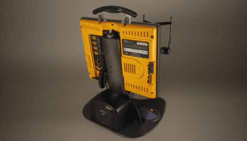 Rear view of the Vision Restoration Therapy device showing the yellow base unit, handle, ventilation areas, and adjustable support stand.