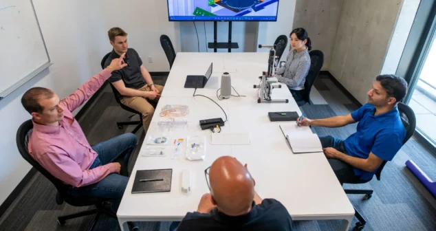 An EE partner explains an electrical architecture decision to the client team during design review