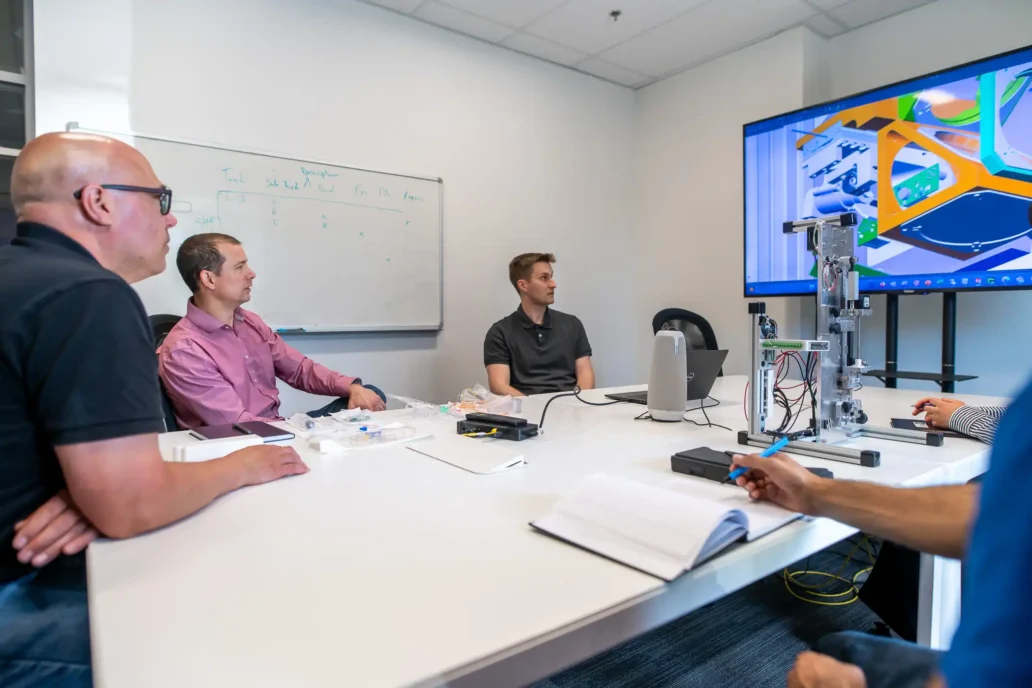 Engineering team reviews early-stage medical device design and manufacturability during a design transfer meeting at StarFish Medical.