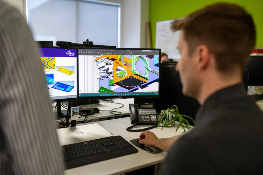 StarFish Medical engineer reviewing FEA simulation and CAD model for medical device development