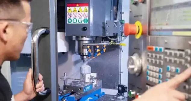 Engineer machining medical device components on a CNC milling machine.