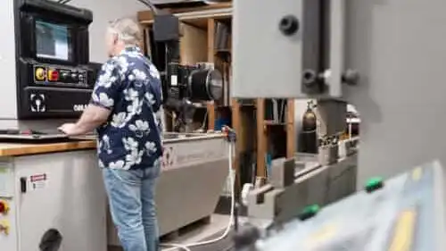 Technician working at a control panel in the Irvine prototyping lab.