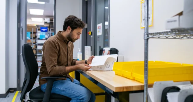 Engineer reviewing design documents at a workstation in the Toronto office.