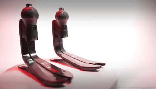 Two ShockWave prosthetic feet with spherical shock units displayed side by side on a reflective surface.