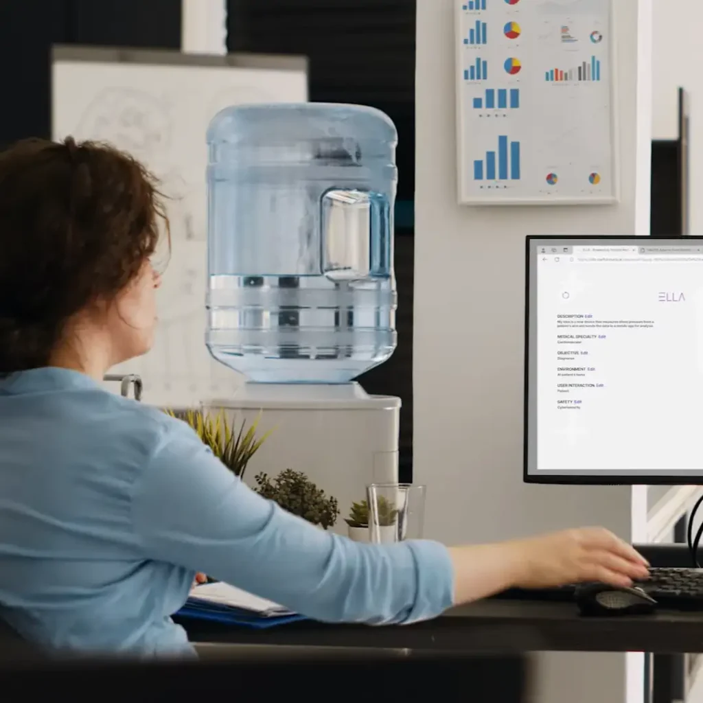 Woman sitting at desk working with regulatory tool