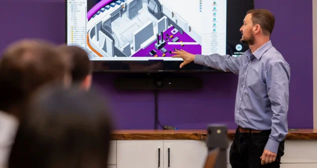 Engineer presenting a 3D CAD model during a design review meeting at StarFish Medical.