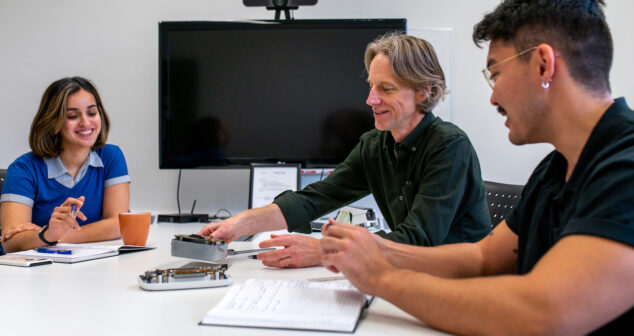 Medical device development team reviewing a prototype device during a product definition meeting