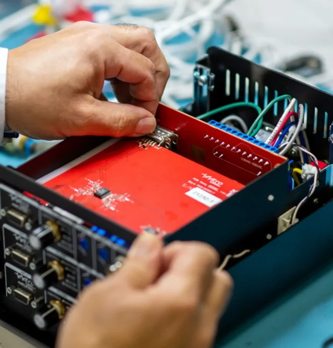 Engineer assembling a medical device circuit board during product development