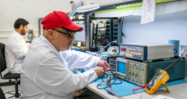 Small Manufacturing Accessibiity: Two assembly workers putting together units on manufacturing floor.