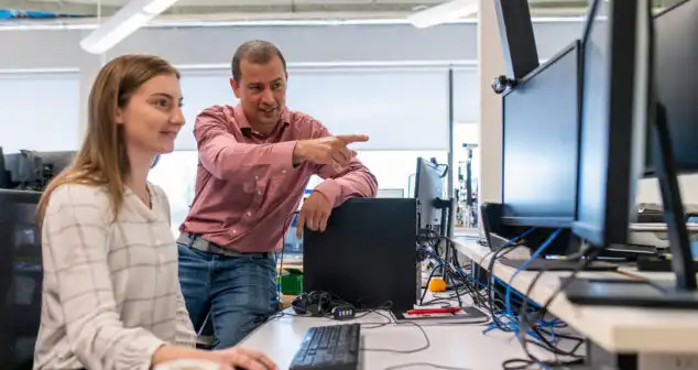 Project manager guiding engineer in agile program management for medical device development and seamless manufacturing transitions.