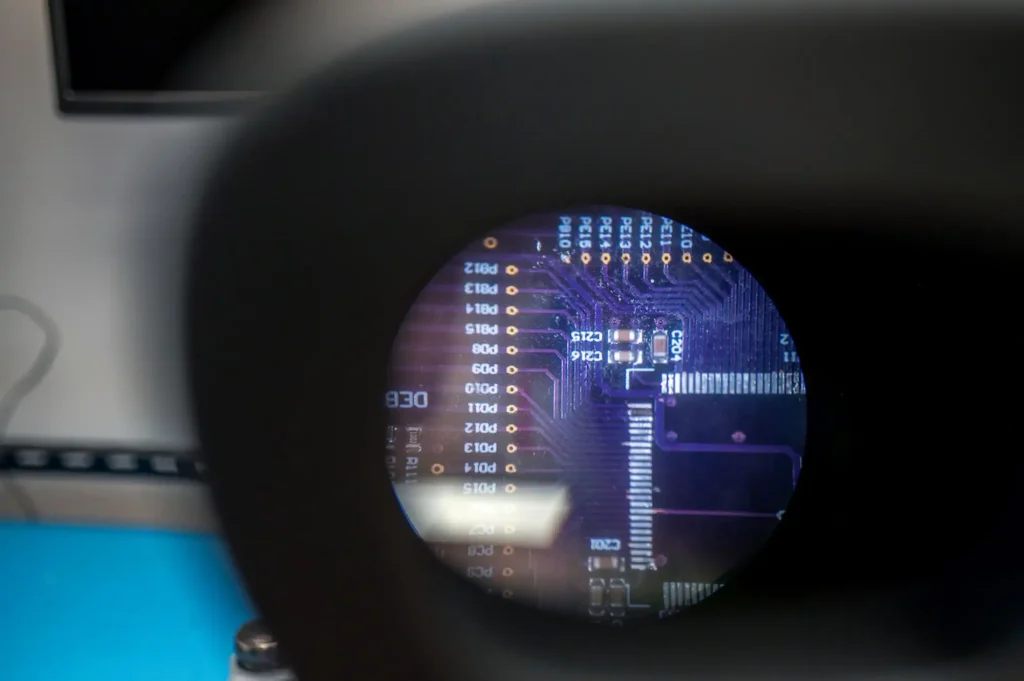 Magnified view of printed circuit board inspection during PCBA bring-up for medical device prototype development.