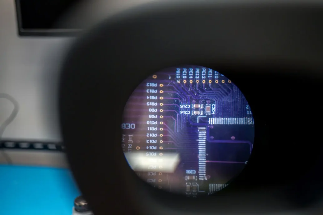 Magnified view of printed circuit board inspection during PCBA bring-up for medical device prototype development.