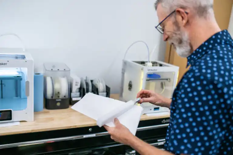 Medical Device Product Engineering Services
QA professional reviewing paperwork in front of a medical device