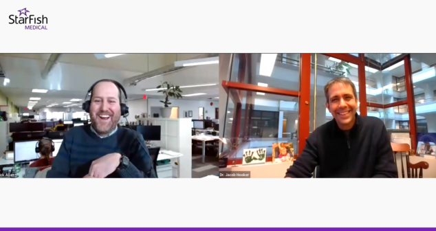 A screenshot from a virtual webinar or video call hosted by StarFish Medical. On the left, a man labeled 'Nick Allan' is wearing a headset and laughing, sitting in an open office space with multiple computer monitors and employees in the background. On the right, a man labeled 'Dr. Jacob Hooker' is smiling while sitting in an office with large windows, framed pictures, and artwork behind him. The image has a white background with the StarFish Medical logo at the top.