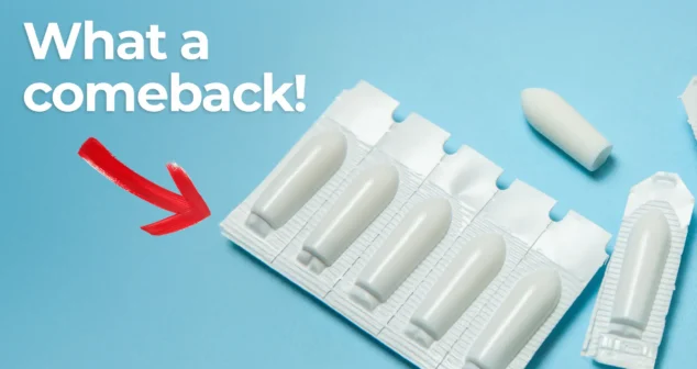 Illustration of suppository drug delivery method. Rectangular blister pack of suppositories, which are making a comeback in drug delivery, on a blue background with one suppository placed outside the packaging. Large bold text reads 'What a comeback!' with a red arrow pointing toward the suppositories, suggesting renewed interest or relevance.