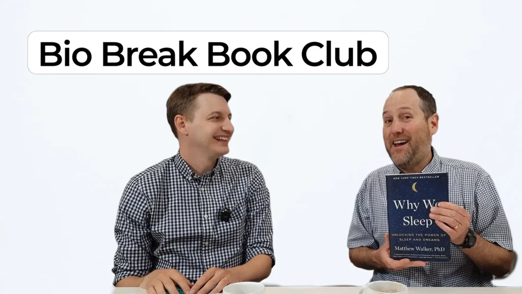 Nick Allan and Nigel Syrotuck smiling during a Bio Break Book Club episode. Nigel holds the book Why We Sleep by Matthew Walker.