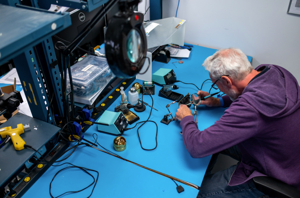 Technician working on medical device in shop