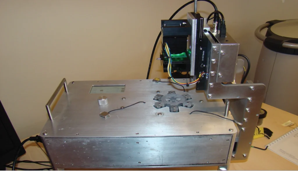 Test fixture used to quantify stress, strain, and optical quality for accommodating intraocular lenses