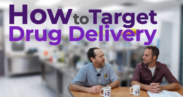 Two professionals engaged in a discussion at a wooden table in a laboratory setting, with the text 'How to Target Drug Delivery' prominently displayed above them. One participant wears a plaid shirt, while the other dons a checkered shirt, and both have coffee mugs featuring their names. The background showcases a blurred laboratory environment, adding a professional and scientific atmosphere to the scene.